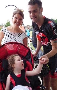 Sophie: young girl holds her dad's hand and her mum smiles