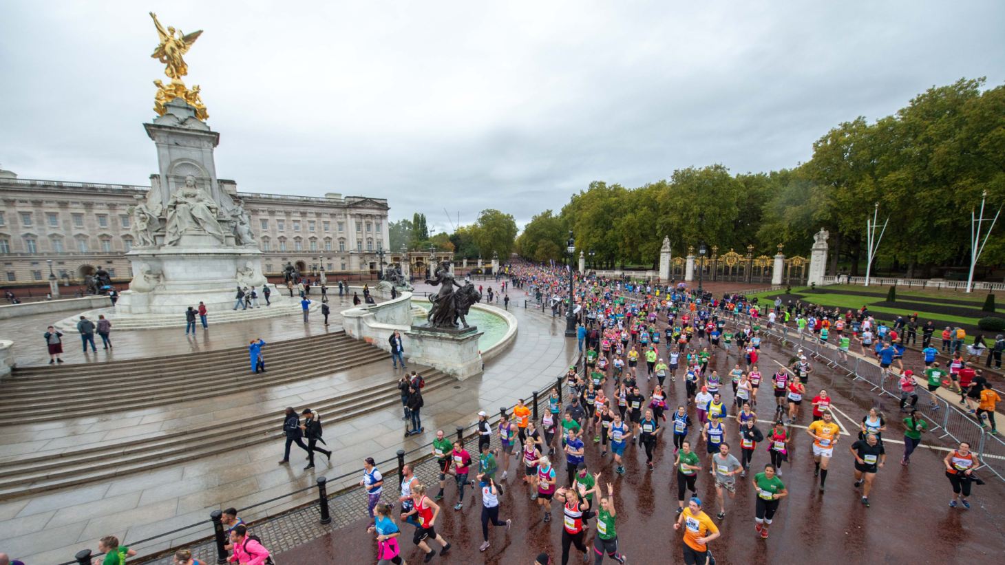 Runners running outside Buckingham Palace during the Royal Parks half marathon