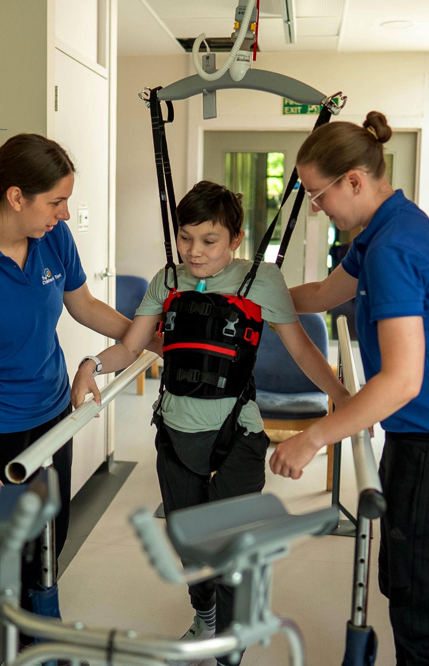 Leo walking in a hoist in physiotherapy