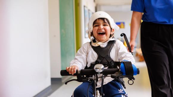 Siddique smiling whilst cycling