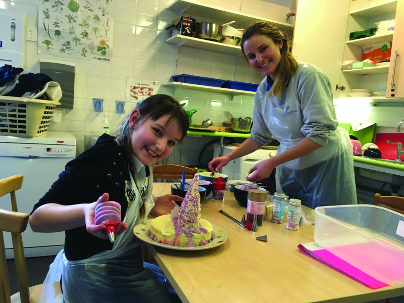 Madison baking at The Children's Trust