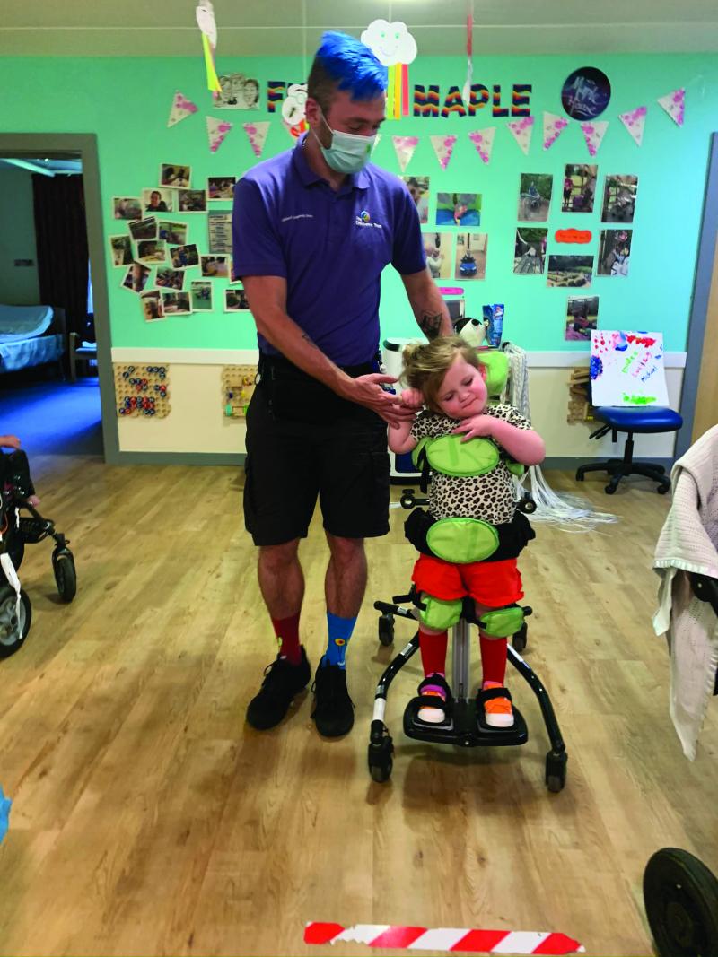Mila in a standing frame at The Children's Trust