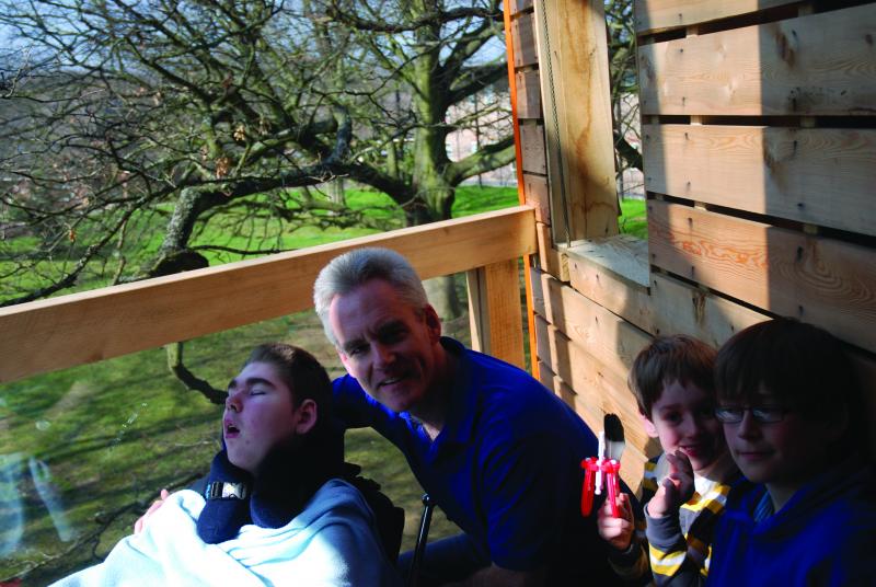 Robbie in the treehouse at The Children's Trust