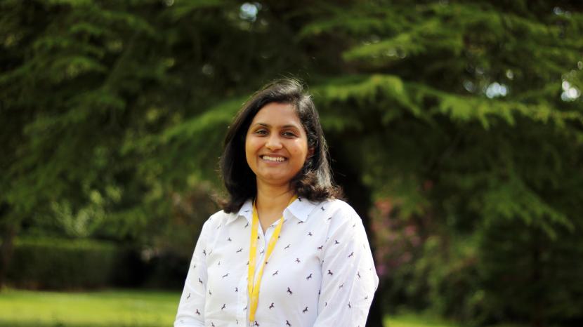 Volunteer standing outdoors smiling at the camera